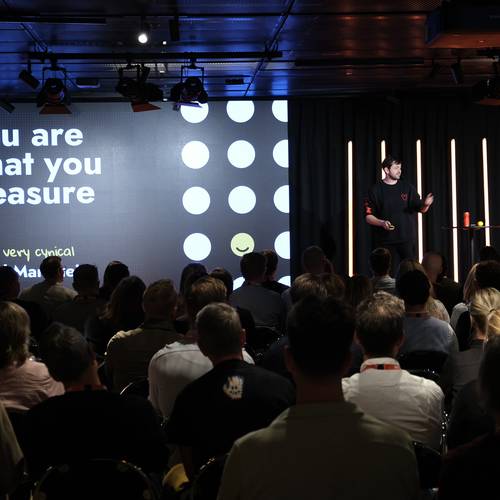 A croud looking at David Mannheim on stage during CJAM 2025 with keynote "You are what you measure"