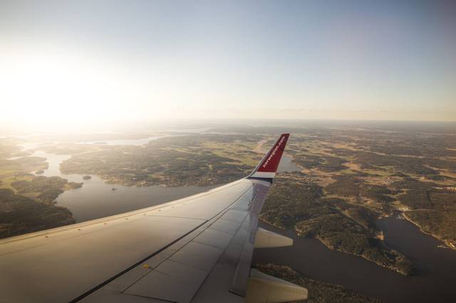 Norwegian airplane with landscape in background