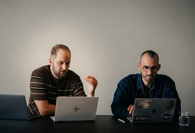 Two men solving work problems together.
